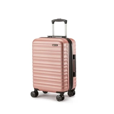 Abbildung von Amazon Basics Hartschalen Handgepäck, Erweiterbarer Handgepäckkoffer (55 cm), Kratzfeste ABS Schale, 4 Rollen, Roségold