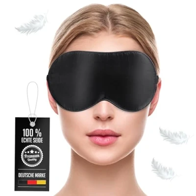 Abbildung von Liebesfreunde® Premium Augenmaske aus natürlicher Seide hautfreundlich und verstellbar Schlafmaske für Frauen Männer, Augenbinde, schwarz
