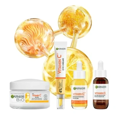 Abbildung von Garnier Vitamin C Set Glow Booster für Tag und Nacht aus Brightening Anti Dark Spot Serum, Augenpflege Nachtserum Tagescreme, 4 teilig