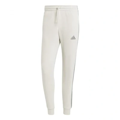 Abbildung von adidas Herren Essentials Fleece 3 Stripes Tapered Cuff Pants, Alumina, S